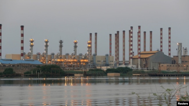 FILE - A general view of the Abadan oil refinery in southwest Iran, as seen from the Iraqi side of the Shatt al-Arab waterway in Al-Faw, south of Basra, Iraq, Sept. 21, 2019.
