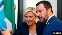 FILE - French far-right leader Marine Le Pen and Italy's far-right leader and interior minister, Matteo Salvini, arrive to hold a news conference in Rome, Oct. 8, 2018.