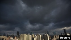 Dark clouds cover the sky in downtown Shanghai, August 6, 2012.