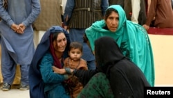 Relatives react in front of a hospital, where their family member has been transferred for treatment after a truck bomb blast in Balkh province, in Mazar-i-Sharif, Afghanistan Aug. 25, 2020.