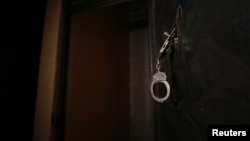 FILE - Handcuffs are pictured inside a prison.