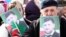 FILE - People hold portraits of Chechen leader Ramzan Kadyrov as they take part in a rally marking the 13th anniversary of the adoption of the Constitution of Russian region of Chechnya, in the regional capital of Grozny, March 23, 2016.