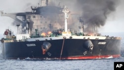 This undated photo released by the private security firm Ambrey shows the oil tanker Sounion burning in the Red Sea. 