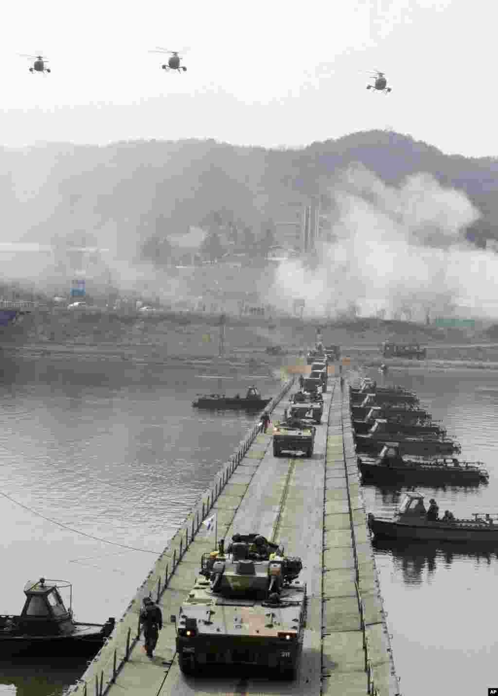 South Korean Army armored vehicles cross a pontoon bridge during an exercise against possible attacks by North Korea near the demilitarized zone in Hwacheon, South Korea, April 1, 2013.