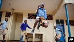 Schoolchildren joke around and play at the Olympic Primary School in Kibera, one of the capital Nairobi's poorest areas, in Kenya, Oct. 12, 2020. 