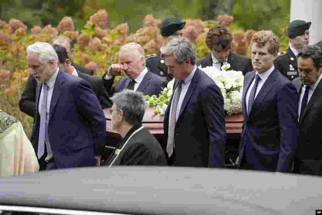 Pallbearers Max Kennedy, left, Chris Kennedy, behind center left, both sons of the late Ethel Kennedy, and Matt Kennedy, center front, and, Joseph Kennedy III, front second from right, both grandsons of Ethel Kennedy, carry her casket from Our Lady of Victory church, following funeral services, Oct. 14, 2024, in Centerville, Massachusetts.