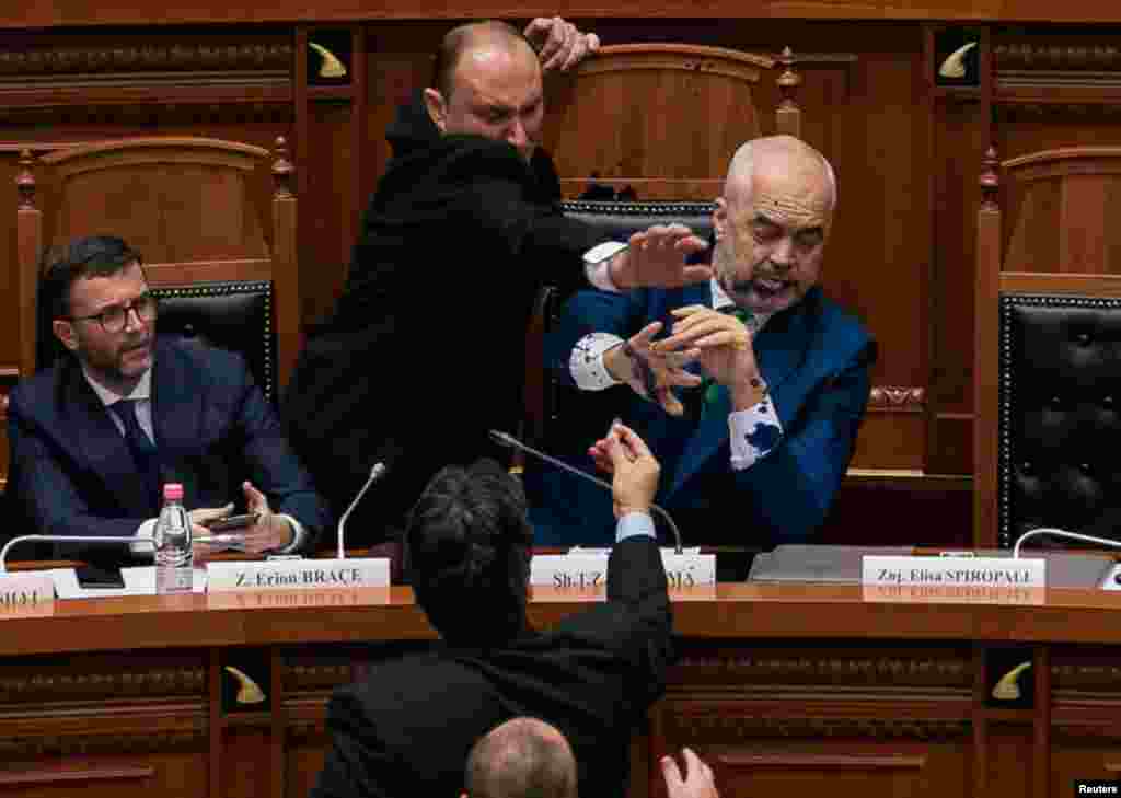 Albania&#39;s Prime Minister Edi Rama reacts as ink is thrown at him by members of the opposition during parliamentary session in Tirana.