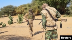 FILE - Fighters from Permanent Strategic Framework for the Defense of the People of Azawad patrol in Tinzaouaten, northern Mali, Nov. 27, 2024.