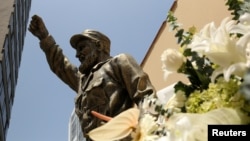 At the Cuban embassy in Lima, Peru, flowers have been placed next to a statue of Cuban revolutionary leader Fidel Castro following the announcement of his death, Nov. 28, 2016. 