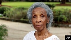 FILE - Josephine Wright poses in her yard facing a barren plot under development in Hilton Head Island, S.C., June 2023. Wright, who drew national attention as she fought off developers, died January 7, 2024, at her Hilton Head home.