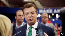 FILE - Paul Manafort, then chairman of Republican Donald Trump's presidential campaign, talks to reporters on the floor of the Republican National Convention at Quicken Loans Arena in Cleveland, July 17, 2016.