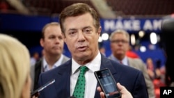 FILE - Paul Manafort, then chairman of Republican Donald Trump's presidential campaign, talks to reporters on the floor of the Republican National Convention at Quicken Loans Arena in Cleveland, July 17, 2016.