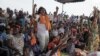 Opposition supporters react to an announcement that the parliamentary elections set for July 21 will be pushed back, during an opposition rally to protest the start of campaigning, in Lome, Togo, July 6, 2013. 