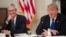 FILE - U.S. President Donald Trump speaks alongside Apple CEO Tim Cook in the State Dining Room of the White House in Washington, March 6, 2019. 