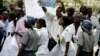 FILE - Zimbabwean riot policemen stand in front of doctors and nurses who are demonstrating over the deteriorating health system, outside Parirenyatwa group of hospitals in Harare, Nov. 18, 2008.