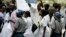 FILE - Zimbabwean riot policemen stand in front of doctors and nurses who are demonstrating over the deteriorating health system, outside Parirenyatwa group of hospitals in Harare, Nov. 18, 2008.