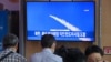 People watch a television screen showing a news broadcast with file footage of a North Korean missile test, at a railway station in Seoul on Sept.13, 2023.