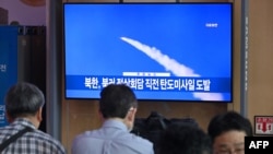 People watch a television screen showing a news broadcast with file footage of a North Korean missile test, at a railway station in Seoul on Sept.13, 2023.