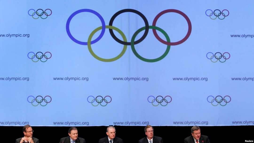 FILE - United States Olympic Committee officials and International Olympic Committee executives address media after signing SportAccord convention, Quebec City, May 2012.