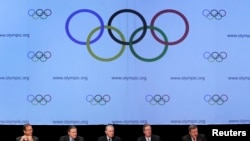 FILE - United States Olympic Committee officials and International Olympic Committee executives address media after signing SportAccord convention, Quebec City, May 2012.