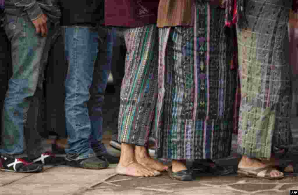 People wait in a line to vote during the country's general elections in Santiago Atitlan, Guatemala, Sunday, Sept. 11, 2011. Polls have indicated that Otto Perez Molina of the Patriotic Party, a former army general, is the leading candidate in Sunday's el