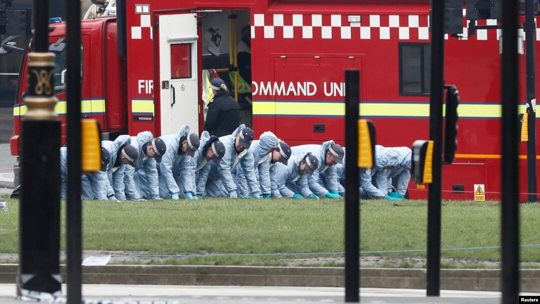 Police officers search an area of Parliament Square the morning after an attack in London, Britain, March 23, 2017. 