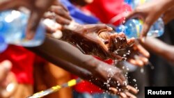 FILE - School children wash their hands during an activity to mark Global Handwashing Day at Thirime primary school in Kikuyu, near Kenya's capital Nairobi.
