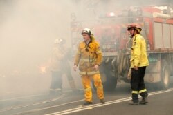 A firefighting crew battles a fire near Burrill Lake, Australia, Jan. 5, 2020.