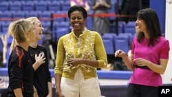 First lady Michelle Obama and Samantha Cameron, wife of British Primer Minister David Cameron, talk with United States Women's National Soccer Team midfielder Lori Ann Lindsey, left, and defender Becky Sauerbrunn as they join with students participating i