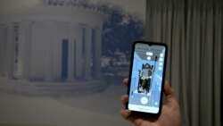 Museum technician Kostas Baskakis uses an app at the Olympic Museum in Athens, Greece, Tuesday, Nov. 9, 2021. (AP Photo/Thanassis Stavrakis)