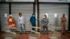 Residents of Yeoville neighborhood of Johannesburg, South Africa, wait in line to enter a grocery store, April 3, 2020. 