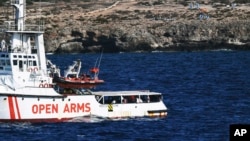 The Open Arms vessel with 107 migrants on board is anchored off the Sicilian vacation and fishing island of Lampedusa, southern Italy, Aug. 19, 2019. 