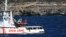 The Open Arms vessel with 107 migrants on board is anchored off the Sicilian vacation and fishing island of Lampedusa, southern Italy, Aug. 19, 2019. 
