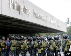 Members of the Philippine National Police Special Action Force conduct a raid to simulate an attack as part of heightened security efforts leading up to next week's APEC (Asia Pacific Economic Cooperation) Summit in Manila, Nov. 14, 2015.