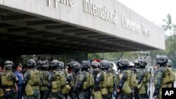 Members of the Philippine National Police Special Action Force conduct a raid to simulate an attack as part of heightened security efforts leading up to next week's APEC (Asia Pacific Economic Cooperation) Summit in Manila, Nov. 14, 2015.