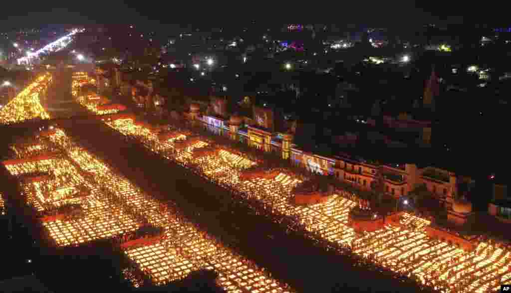 People light lamps on the banks of the river Saryu in Ayodhya, India. Over 900,000 earthen lamps were lit and were kept burning for 45 minutes as the north Indian city of Ayodhya retained its Guinness World Record for lighting oil lamps as part of the Diwali celebration &ndash; the Hindu festival of lights.&nbsp;