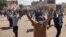 FILE - Sudanese protesters rallying against the military take to the streets of Khartoum, Jan. 6, 2022. 