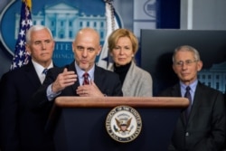 FILE - FDA Commissioner Stephen Hahn, with Vice President Mike Pence, White House coronavirus coordinator Dr. Deborah Birx and Dr. Anthony Fauci of the National Institute of Allergy and Infectious Diseases, speaks at the White House, March 6, 2020.