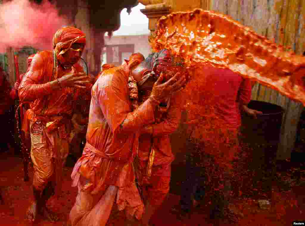 Hindu devotees take part in the religious festival of Holi in Nandgaon village, in the state of Uttar Pradesh, India.