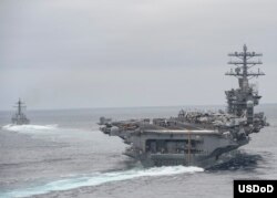 FILE - Ships assigned to the Nimitz Carrier Strike Group participate in a strait transit exercise in the Pacific Ocean in this April 3, 2017 photo.