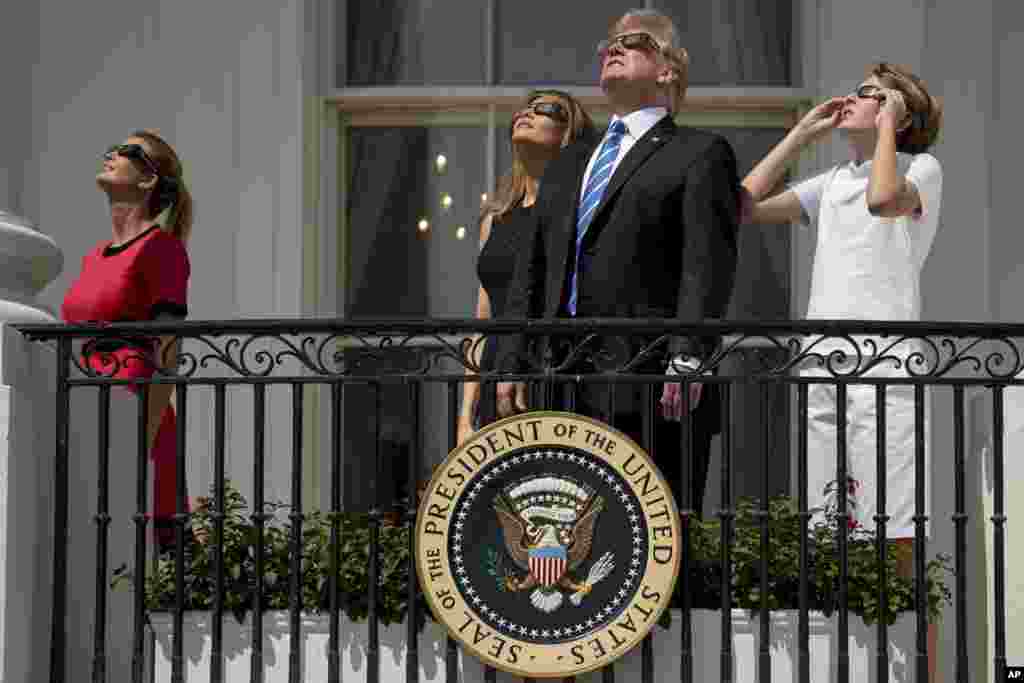 From left, Ivanka Trump, daughter of President Donald Trump, first lady Melania Trump, President Donald Trump, and their son Barron Trump view the solar eclipse at the White House in Washington, D.C., Aug. 21, 2017.