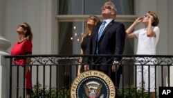 From left, Ivanka Trump, the daughter of President Donald Trump, first lady Melania Trump, President Donald Trump, and their son Barron Trump view the solar eclipse, Aug. 21, 2017, at the White House in Washington.