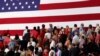 FILE - People turn to face a U.S. flag during the playing of the national anthem before U.S. President Donald Trump rallies with supporters during a Make America Great Again rally in Southaven, Mississippi, U.S. Oct. 2, 2018. 