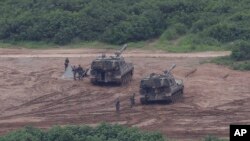 South Korean army soldiers prepare their military exercise in Paju, South Korea, near the border with North Korea, Sunday, July 30, 2017. 