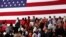 FILE - People turn to face a U.S. flag during the playing of the national anthem before U.S. President Donald Trump rallies with supporters during a Make America Great Again rally in Southaven, Mississippi, U.S. Oct. 2, 2018. 