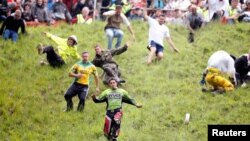 FILE - Chris Anderson runs down Cooper's Hill chasing a round of cheese in 2009. (Action Images / Steven Paston Livepic/File Photo)