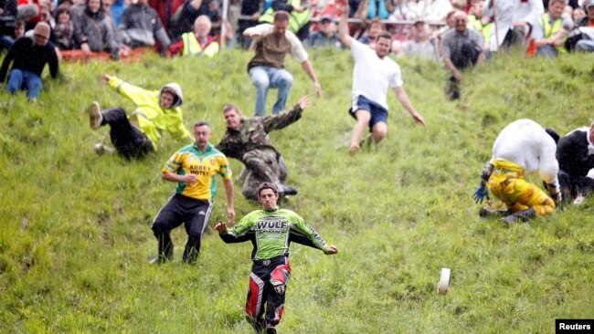 FILE - Chris Anderson runs down Cooper's Hill chasing a round of cheese in 2009. (Action Images / Steven Paston Livepic/File Photo)