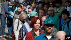 Job seekers line up in the hundreds to attend a marijuana industry job fair hosted by Open Vape, in Downtown Denver, Colorado, March 27, 2014.