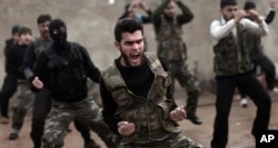 FILE - Syrian rebels attend a training session in Maaret Ikhwan near Idlib, Syria.