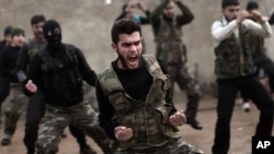 FILE - Syrian rebels attend a training session in Maaret Ikhwan near Idlib, Syria. More and more Georgian nationals are joining the Islamic cause in Syria.